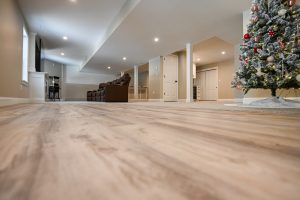 Spacious basement with Christmas tree and seating.