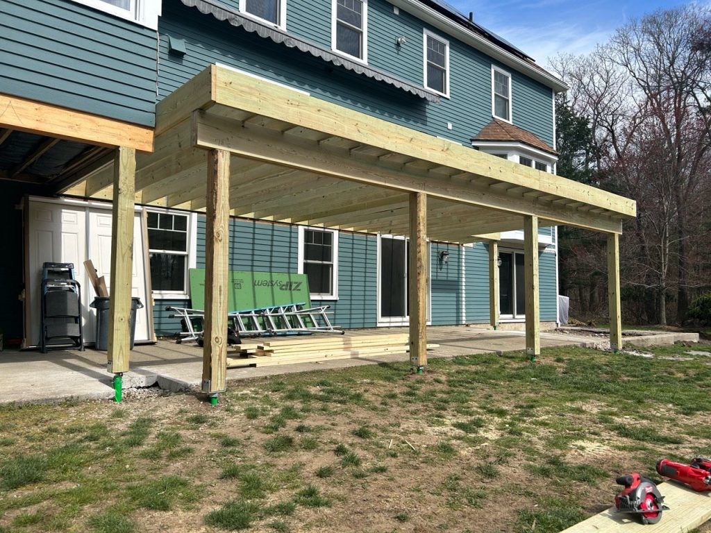 Wooden patio cover construction in progress.