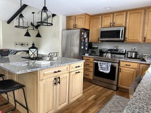Modern kitchen with wooden cabinets and granite countertops.