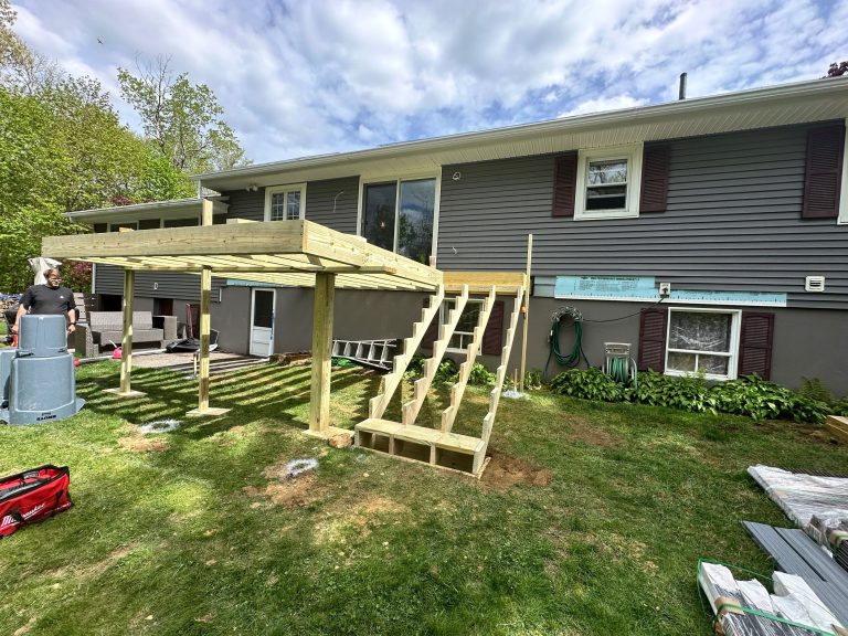 House renovation with new wooden deck being built.